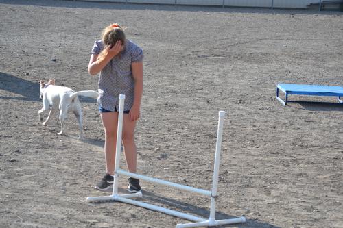 Photo of young girl and her dog competing in dog agility...dog is running away. Photo by Lisa Terry.