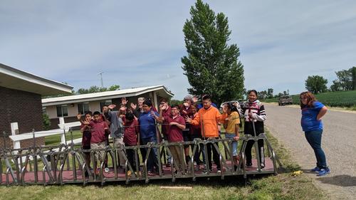 Students and staff standing on the assembled bridge. Photo by Jodie DeLay