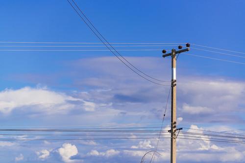Photo looking up at phone pole and it's wires, provided by Bigstock.com