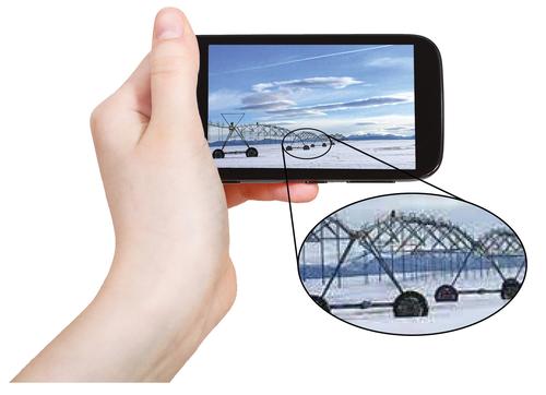 hand holding smartphone with close-up of that image showing pixellation