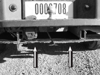 Back end of truck near hitch with two arrows pointing where the seed and mud mixture was found