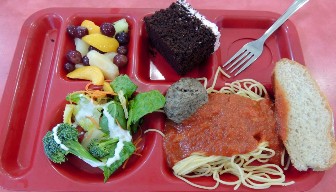 A school lunch tray with various dishes