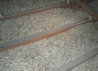 Photo of an attic with Zonolite loose-fill insulation.