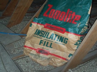 Photo of a bag of Zonolite insulating fill in an attic.