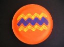 A cartoon image of a paper plate maraca