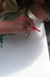 A child practicing a straw-blown painting